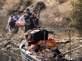 Forensic police transport what they believe are the remains of a six-year-old Filipina from a lake at Xyliatos, about 50 kilometres southwest of the Cypriot capital Nicosia, on June 12, 2019. Cypriot authorities today recovered at the bottom of a lake, the seventh and last victim of a suspected serial killer, police said. A 35-year-old Greek Cypriot army officer is in custody after reportedly confessing to murdering five foreign women and two of their daughters in a string of killings that have left the Mediterranean holiday island in shock. (Photo by Iakovos Hatzistavrou, Getty Images)