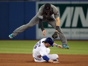 Nick Ahmed of the Arizona Diamondbacks turns a double play as he avoids Danny Jansen of the Toronto Blue Jays during MLB action at Rogers Centre on June 7, 2019 in Toronto. (Tom Szczerbowski/Getty Images)
