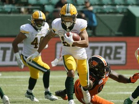 Eskimos' Jordan Robinson eludes a tackle by Lions' Ebo Ogundeko during pre-season CFL action in Edmonton on May 26, 2019.