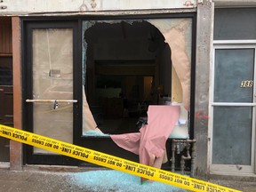 A man was wounded in a shooting at Queen St. and Spadina Ave. Bullets also hit the front of a store. (Ernest Doroszuk, Toronto Sun)