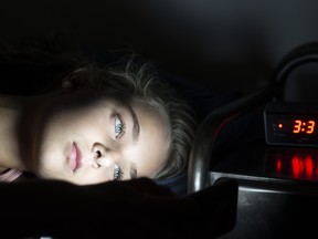 Girl using her smartphone late at night