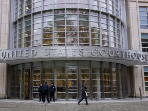 Police stand on duty at the Brooklyn Federal Court in New York.