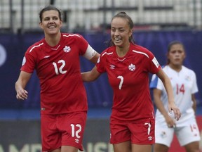 Canada midfielder Julia Grosso celebrates with forward Christine Sinclair after Sinclair scored a goal during the first half of a soccer match at the semifinals of the CONCACAF women's World Cup qualifying tournament in Frisco, Texas, Sunday, Oct. 14, 2018.
