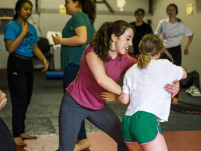 Gemma Sheehan, founder of Girls Who Fight, leads a class on mixed martial arts techniques at Undisputed MMA in Toronto, Ont., on Saturday, May 25, 2019. With her is student Ella Rose, 11. (Ernest Doroszuk/Toronto Sun/Postmedia)