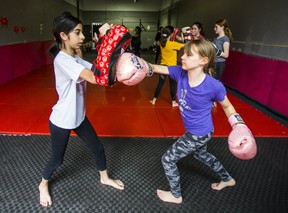 Claire Bhagat, 11 (left) and Abbey Ramsay-Brown, 12, practice mixed martial arts technique during a Girls Who Fight class at Undisputed MMA in Toronto, Ont., on Saturday May 25, 2019. Ernest Doroszuk/Toronto Sun/Postmedia)
