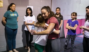 Gemma Sheehan, founder of Girls Who Fight, hugs a student before leading a class on mixed martial arts techniques at Undisputed MMA in Toronto, Ont., on Saturday May 25, 2019. (Ernest Doroszuk/Toronto Sun/Postmedia)