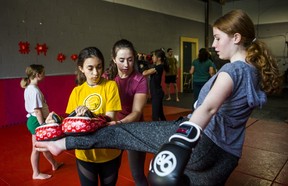 Gemma Sheehan, founder of Girls Who Fight, leads a class on mixed martial arts techniques at Undisputed MMA in Toronto, Ont., on Saturday, May 25, 2019. Listening to her are Emma Zammit, 14 (left), and Kayleigh Lambe, 13. (Ernest Doroszuk/Toronto Sun/Postmedia)