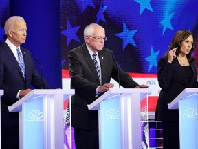Democratic presidential candidates (from left to right) former Vice President Joe Biden, Sen. Bernie Sanders (I-VT) and Sen. Kamala Harris (D-CA) take part in the second night of the first Democratic presidential debate in Miami on Thursday, June 27, 2019.