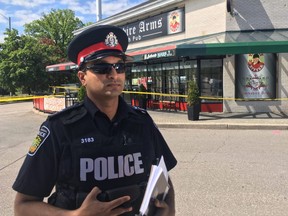 Peel police Const. Akhil Mooken speaks to media outside the Yorkshire Arms in Mississauga after Wednesday night's shooting.