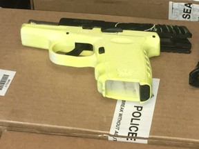 Dozens of firearms seized in Project Kraken, including this yellow handgun, were on display during a news conference at headquarters on Friday, June 28, 2019. (Joe Warmington/Toronto Sun/Postmedia Network)