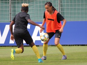 Defender Estelle Johnson, right, battles for the ball with Cameroon teammate Genevieve Ngo during a training session at the Centre Bernard-Gassett Terrain d'honneur Mama Ouattara in Montpellier, France on Sunday June 9.