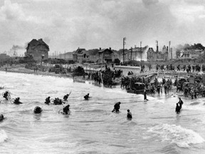 This photo, provided by the Imperial War Museum to AFP/Getty Images, was taken on June 6, 1944, and shows Canadian soldiers from 9th Brigade landing with their bicycles at Juno Beach in Bernieres-sur-Mer as Allied forces storm Normandy beaches in northwestern France on D-Day.