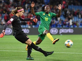 Canada's goalkeeper Stephanie Labbe (L) kicks the ball in front of Cameroon's forward Henriette Akaba during the France 2019 Women's World Cup Group E football match between Canada and Cameroon, on June 10, 2019, at the Mosson Stadium in Montpellier, southern France.