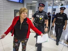 Toronto Sun columnist Sue-Ann Levy is escorted by Toronto Police out of a community meeting at the Birchmount Community Centre in Toronto, Ont. on Wednesday June 12, 2019. The meeting was about the proposed Thunder Woman Healing Lodge & Transitional Housing at 2217 Kingston Rd. in the Cliffside area of Scarborough. (Ernest Doroszuk/Toronto Sun/Postmedia)