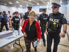 Toronto Sun columnist Sue-Ann Levy is escorted by Toronto Police out of a community meeting at the Birchmount Community Centre in Toronto, Ont. on Wednesday June 12, 2019. The meeting was about the proposed Thunder Woman Healing Lodge & Transitional Housing at 2217 Kingston Rd. in the  Cliffside area of Scarborough.