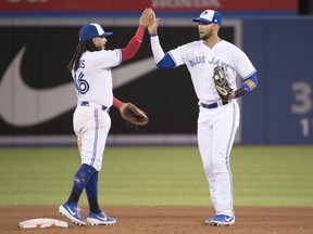 Blue Jays outfielder Lourdes Gurriel Jr. (right) celebrates with shortstop Freddy Galvis (left) after defeating the Royals at Rogers Centre in Toronto on Friday, June 28, 2019.