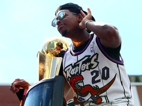 Kyle Lowry of the Toronto Raptors holds the championship trophy during the team's Victory Parade June 17, 2019 in Toronto.