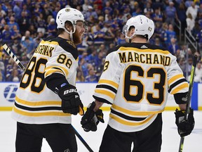 Boston Bruins right wing David Pastrnak (88) and left wing Brad Marchand (63) celebrate a goal against the St. Louis Blues during Game 6  of the Stanley Cup final at Enterprise Center. (Jeff Curry-USA TODAY Sports)