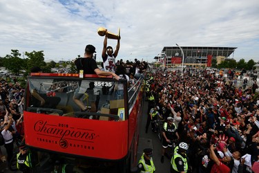 Toronto Raptors guard Kyle Lowry raises the Larry O'Brien NBA Championship Trophy during Raptors victory parade celebration in Toronto, June 17, 2019.   REUTERS/Moe Doiron