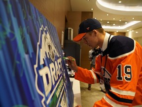 Philip Broberg signs his autograph after being selected eighth overall by the Edmonton Oilers during the first round of the 2019 NHL Draft at Rogers Arena in Vancouver on June 21, 2019.