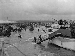 Photo by Lieutenant Gilbert "Gib" Milne  showing Canadian troops landing in Normandy. (DEPT. OF NATIONAL DEFENCE / LIBRARY AND ARCHIVES CANADA)