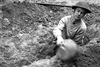 Lieutenant Ken Bell, of the Canadian Army Film and Photo Unit, digs a slit trench in the Normandy beachhead in France on June 10, 1944. (DEPT. OF NATIONAL DEFENCE / LIBRARY AND ARCHIVES CANADA)