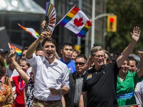Canadian Prime Minister Justin Trudeau (left) and Toronto Mayor John Tory wave to spectators at the Pride parade in downtown Toronto, Ont. on Sunday June 23, 2019.