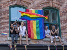 Spectators take in the Pride parade along Yonge St. in downtown Toronto, Ont. on Sunday June 23, 2019.