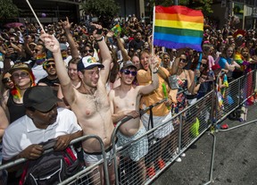 Spectators take in the Pride parade along Yonge St. in downtown Toronto, Ont. on Sunday June 23, 2019.