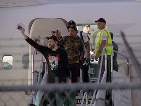 Marc Gasol waves to fans and Danny Green can be seen about to exit the plane, standing next to what appears to be a case used to transport a trophy, as some members of the NBA champion Toronto Raptors and team staff touched down in the city on Saturday, June 15, 2019, after celebrating their big win in Las Vegas. John Hanley photo)