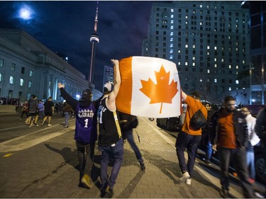 Fans fill the streets of downtown Toronto, Ont. celebrating the Toronto Raptors victory over the Golden State Warriors in the NBA Finals on Friday June 14, 2019.