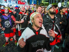 Fans watch the Toronto Raptors take on the Golden State Warriors during Game 6 NBA Finals action screened at Jurassic Park outside of the Scotiabank Arena in Toronto, Ont. on Thursday June 13, 2019.