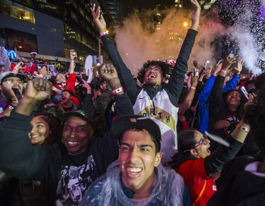 Celebrating theToronto Raptors victory over the  Golden State Warriors in the NBA Finals at Jurassic Park outside of the Scotiabank Arena in Toronto, Ont. on Thursday June 13, 2019. Ernest Doroszuk/Toronto Sun/Postmedia