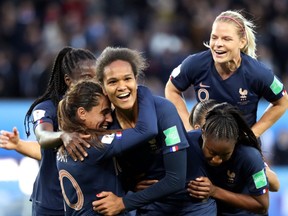 France defender Wendie Renard celebrates scoring her second goal with Amel Majri, left, and teammates at the Parc des Princes Stadium in Paris on June 7, 2019.
