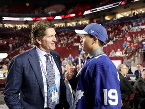 Nicholas Robertson, the 53rd selection overall at the NHL draft, speaks to Maple Leafs coach Mike Babcock at Rogers Arena on Saturday. (Bruce Bennett/Getty Images)