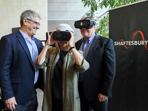 Shaftesbury CEO Christina Jennings tries on a virtual reality headset while execs Ted Biggs, left, and Scott Garvie look on
