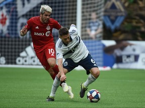May 31, 2019; Vancouver, British Columbia, CAN; Vancouver Whitecaps midfielder Jon Erice (6) controls the ball against Toronto FC midfielder Alejandro Pozuelo (10) during the first half at BC Place.
