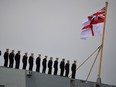 Sailors stand to attention on board HMS Queen Elizabeth, as they wait for the MV Boudicca to pass as it commemorates the 75th anniversary of D-Day, in Portsmouth, Britain, June 5, 2019. (REUTERS/Dylan Martinez)
