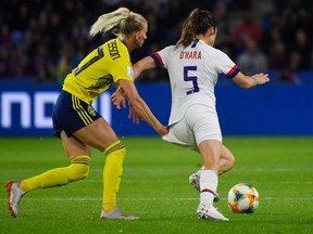 Sweden's forward Sofia Jakobsson L) grabs onto  United States' defender Kelley O'Hara leading to a foul during the France 2019 Women's World Cup Group F football match between Sweden and USA, on June 20, 2019, at the Oceane Stadium in Le Havre, northwestern France.