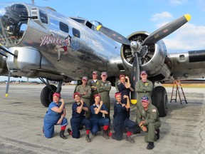 Rosie the Riveter re-enactors pose with Yankee Lady crew members in front of the Yankee Lady B-17 aircraft. The Yankee Lady is part of the Yankee Air Museum near Ypsilanti, Mich. (DESTINATION ANN ARBOR photo)