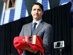 Canada's Prime Minister Justin Trudeau holds the final report during the closing ceremony of the National Inquiry into Missing and Murdered Indigenous Women and Girls in Gatineau, Quebec, Canada, on June 3, 2019. (REUTERS/Chris Wattie)