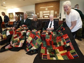 Eleanor Ross poses with 48th Highlander members Sgt. Ken Wells 95, Major Tom White 97, Master Sgt. Herb Pike, 94 and Master Warrant Officer George McLean 99. She made quilts for the men and presented them in honour of the 75th anniversary of D-Day at Moss Park Armoury on Tuesday June 4, 2019.