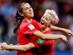 Alex Morgan of the U.S. celebrates scoring her team's 12th goal with Megan Rapinoe during Women's World Cup action against Thailand Tuesday in Reims, France. (REUTERS/Christian Hartmann)