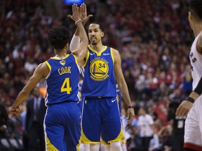 Golden State Warriors players celebrate their win over the Toronto Raptors in Game 2 on Sunday. (Stan Behal/Toronto Sun)