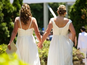 Cheryl Taylor and Jennifer Smith hold hands as they arrive for the Grand Pride Wedding, a mass gay wedding at Casa Loma in Toronto, Canada, on June 26, 2014. (AFP/Getty Images)