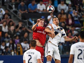 Toronto FC midfielder Liam Fraser competes for the ball with L.A Galaxy forward Zlatan Ibrahimovic during Thursday's game. (USA TODAY SPORTS)