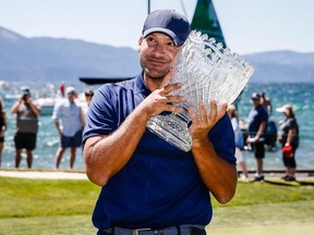 Tony Romo hugs the winner's trophy after winning the American Century Championship at Edgewood Tahoe Golf Course on July 14, 2019 in Stateline, Nevada. (Photo by Jonathan Devich/Getty Images)