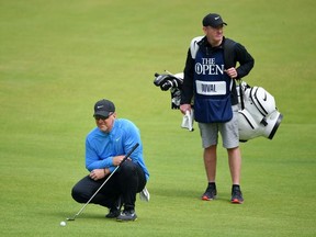 David Duval of the United States looks on with his caddie as he lines up a putt during the first round of the 148th Open Championship held on the Dunluce Links at Royal Portrush Golf Club on July 18, 2019 in Portrush, United Kingdom.