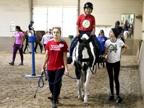 A rider gets some equine therapy at the Card facility in Toronto. (Veronica Henri, Toronto Sun)