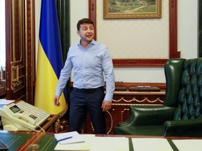Ukraine's President Volodymyr Zelenskiy is seen at his desk in his office at the Presidential Administration building in Kiev, Ukraine June 19, 2019. REUTERS